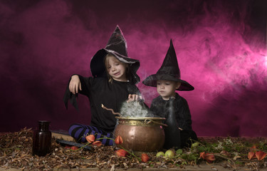 two halloween witches cooking a potion