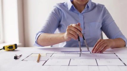 Poster - female architect with compass measuring blueprint