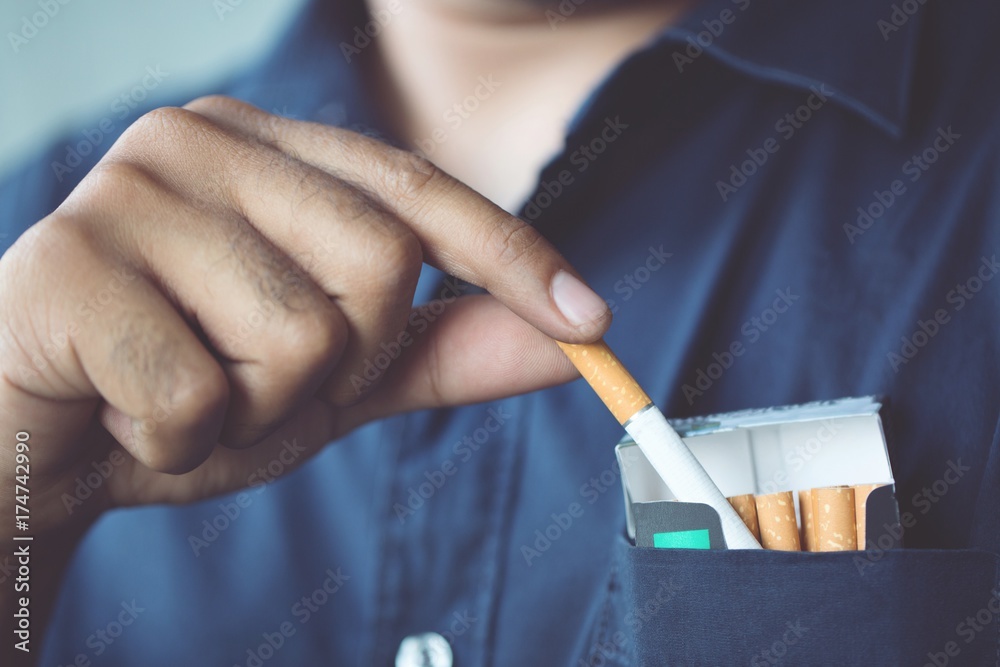 cigarette pick up Man is picking Cigarette pack from the pocket Come up smoking. Stock Photo