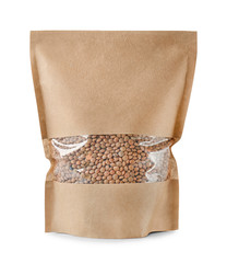 Wall Mural - Paper package with brown lentils on white background