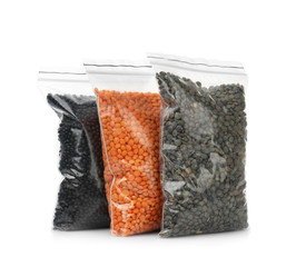 Wall Mural - Lentil beans in plastic bags on white background