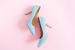 Fashion blog look. Pastel blue women high heel shoes on pink background. Flat lay, top view trendy beauty female background.
