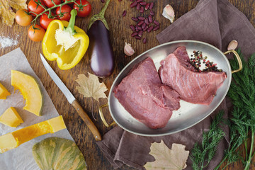 Wall Mural - Fresh beef tenderloin in frying pan with vegetables