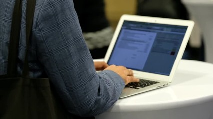 Man works at laptop, back view