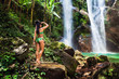 Active lifestyle travel women enjoy adventure in tropical rainforest jungle with amazing waterfall on background scenery nature landscape