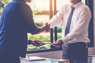 businessman shaking hand after recieve document from delivery man