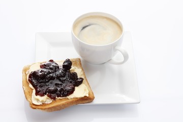 Wall Mural - Porcelain plate with a cup of coffee and toast with cherry jam