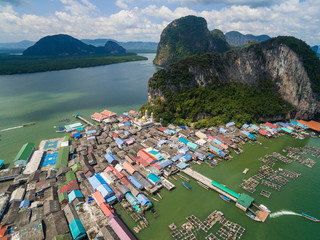 Wall Mural - Top view of fishing village Ko Panyi (Koh Panyee) in Phang Nga Bay, Thailand. Aerial top view of a muslim fisherman village with houses on pillars in the Andaman sea. Phuket, Phang Nga Bay, Thailand