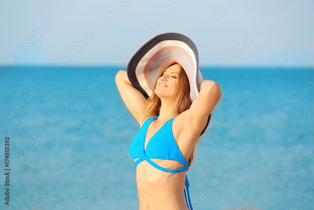 Young woman with nice body on sea beach