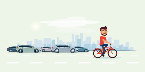 Man on Electric Bicycle on the Street with Cars behind