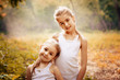© svetabezu - Childhood, family, friendship and people concept - two happy kids sisters hugging outdoors.