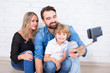 © Di Studio - young parents and little son taking selfie photo
