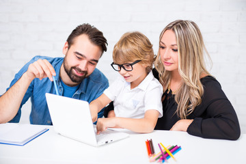 Sticker - happy cute little school boy in glasses doing homework with parents