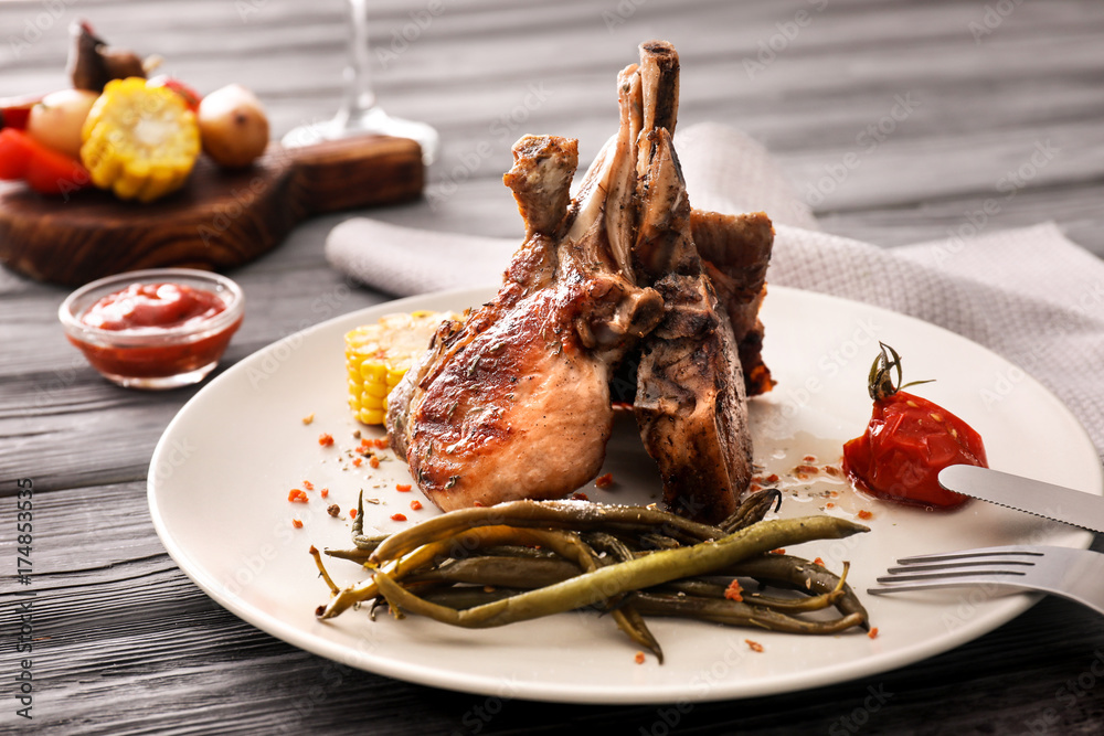 Plate with grilled meat on table