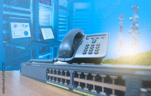 Ip Telephone On Networking Switch With Blurred Server Rack Cabinet
