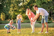 © Africa Studio - Happy family playing football in park on sunny day