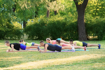 Group of young people doing exercise outdoor