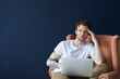 © Anatoliy Karlyuk - People, modern technology, online communication, leisure and relaxation concept. Handsome bearded hipster guy with tattooed arm enjoying wireless internet connection on laptop pc, relaxing in armchair
