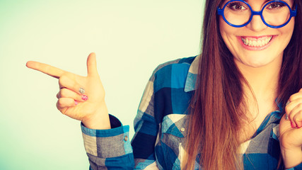 Wall Mural - Happy woman pointing at something with finger