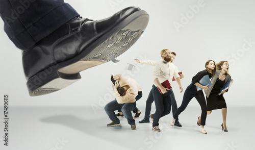 Fotomural Scared and shocked team of young business men and women under boss pressure