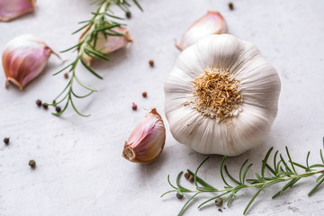 Wall Mural - Garlic. Garlic bulbs. Fresh garlic with rosemary and pepper on white concrete board