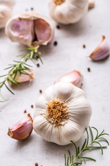 Wall Mural - Garlic. Garlic bulbs. Fresh garlic with rosemary and pepper on white concrete board