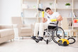 © Elnur - Disabled man with vacuum cleaner at home