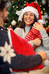 Wall Mural - happy girl surprised with presents on Christmas.