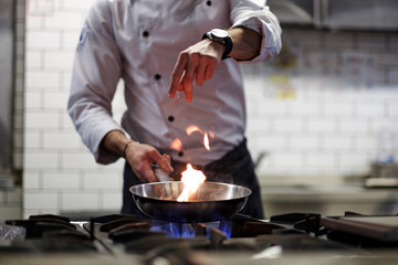 A man cooks cooking deep fryers in a kitchen fire.