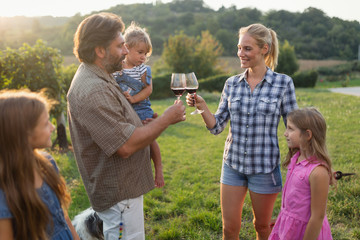 Wall Mural - Wine grower family in vineyard before harvesting