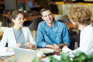 Sticker - Young man and woman listening to applicant during interview in cafe