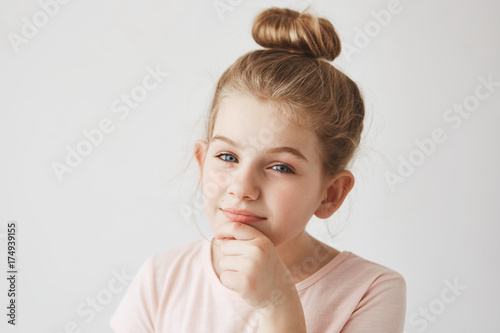 Close Up Portrait Of Funny Girl With Blond Hair In Bun