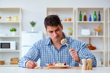 Man Eating Tasteless Food At Home For Lunch
