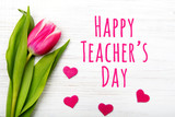 Fototapeta Tulipany - Happy Teacher's day card. Tulip on white wooden background