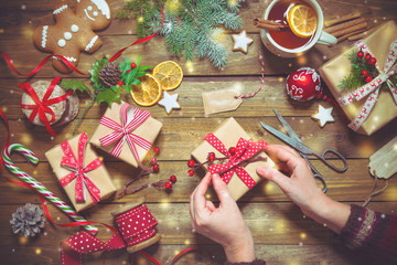 Wall Mural - Female hands wrapping christmas holiday handmade presents