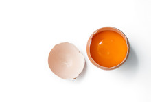 Egg Yolk In Egg Shell, Cracked Egg White Isolated On White Background
