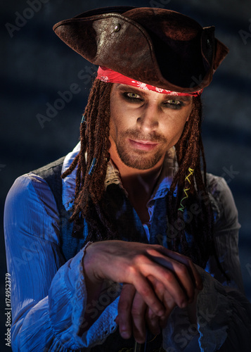 Portrait of a young man in a pirate costume.