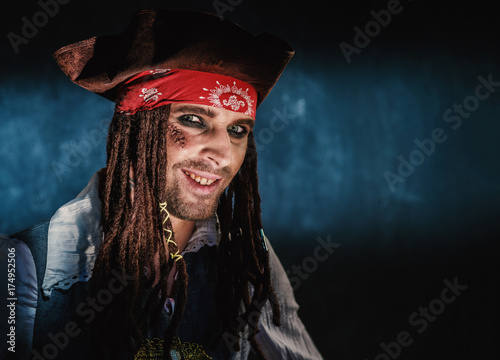 Portrait of a young man in a pirate costume.