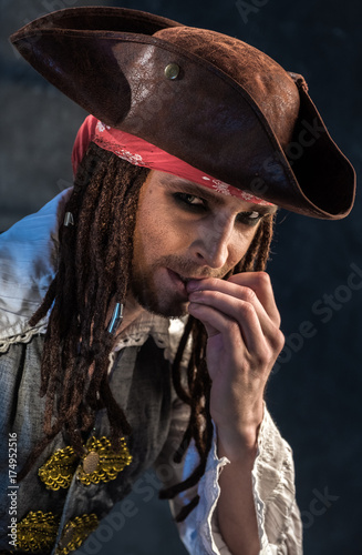 Portrait of a young man in a pirate costume.