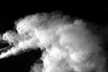 Wall Mural - Explosion of white dust on black background.