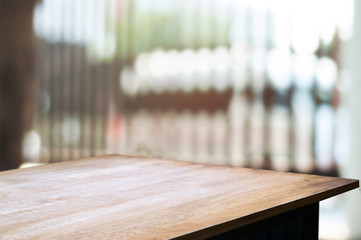 empty wooden desk over blurred interior decoration background
