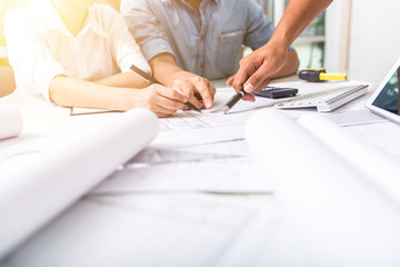 Close up hand of business people pointing at document during team meeting