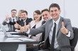 © ASDF - successful business team showing thumbs up