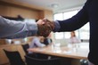 © wavebreak3 - Business people shaking hands during meeting in board room