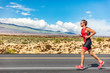Triathlon runner triathlete man running in tri suit at ironman competition race on road. Sport athlete on marathon run training exercising cardio in professional outfit for triathlon. Fitness, Hawaii.