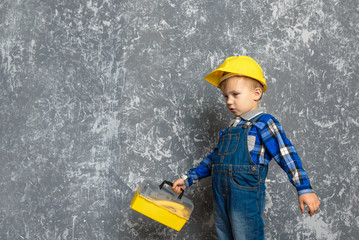 the boy in yellow hard hat and a yellow tool box