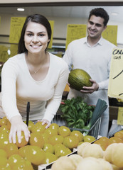 Wall Mural - couple buying fresh seasonal fruits in market