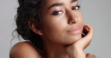 portrait shot of a pretty olive-skinned model with brown eyes, black hair and beautiful smile on whi