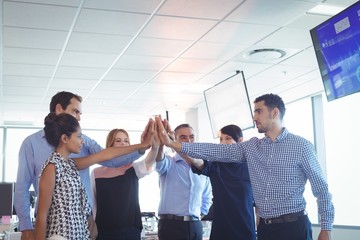 Wall Mural - Business colleagues putting their hands together