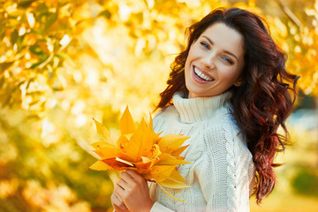 Wall Mural - Autumn woman in autumn park. Warm sunny weather. Fall concept